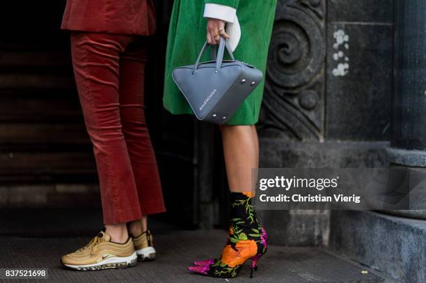 Guest wearing Balenciaga bag and sock boots with floral print outside Fam Irvoll on August 22, 2017 in Oslo, Norway.