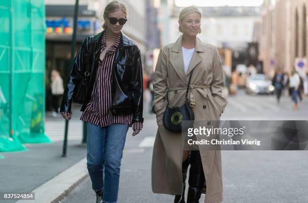 Tine Andrea and Janka Polliani wearing trench coat, Loewe bag, black overknees outside Line of Oslo on August 22, 2017 in Oslo, Norway.