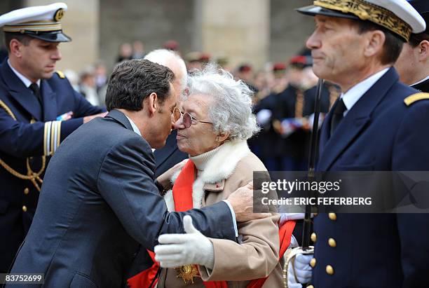 French president Nicolas Sarkozy kisses Gilberte Champion after he gave her the Grand Cross of the Legion of Honour during the Fall military ceremony...
