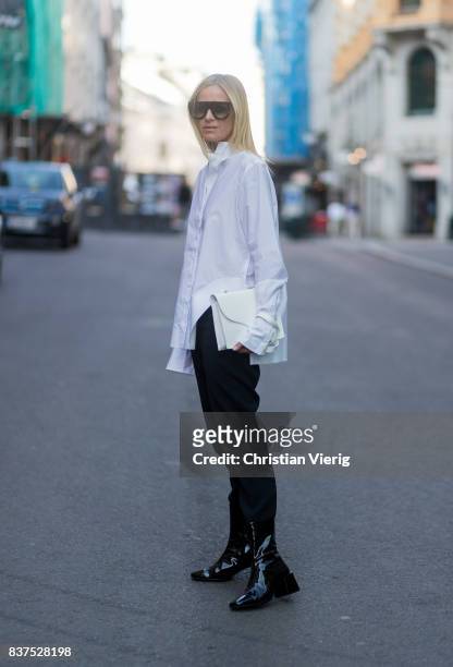 Celine Aagaard wearing white button shirt, black pants and boots outside Line of Oslo on August 22, 2017 in Oslo, Norway.