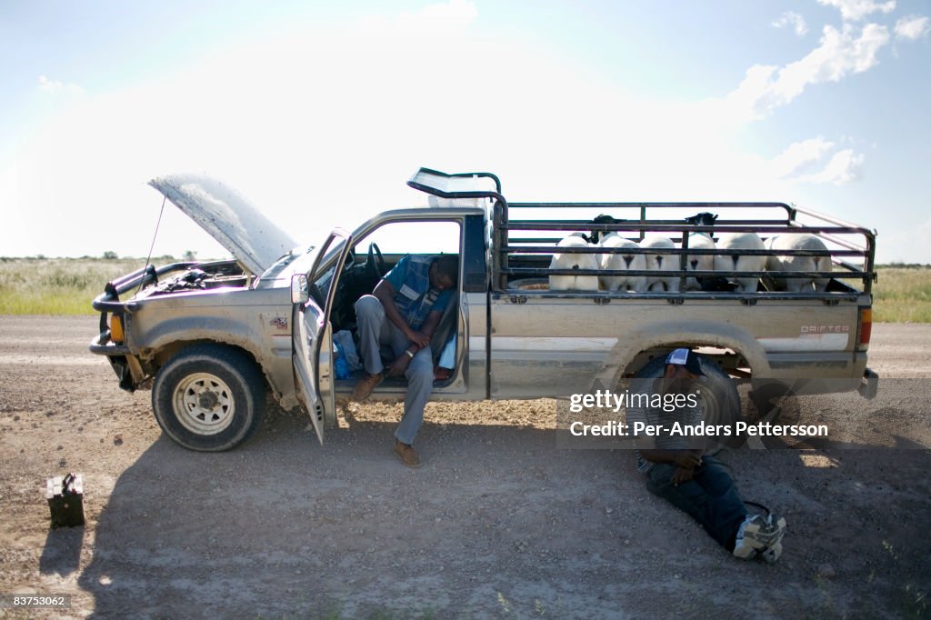 Two men resting after vehicle breakdown
