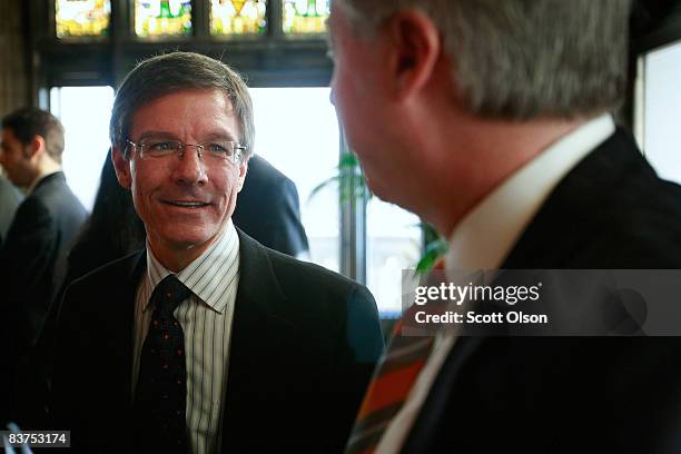 Thomas Wilson, chairman, president and CEO of The Allstate Corporation, speaks with guests following a panel discussion on the global financial...