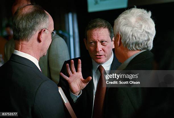 Thomas Pritzker, Chairman of Global Hyatt Corporation , speaks with guests following a panel discussion on the global financial crisis hosted by The...