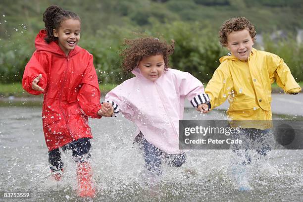 three children running through water - ankle deep in water fotografías e imágenes de stock