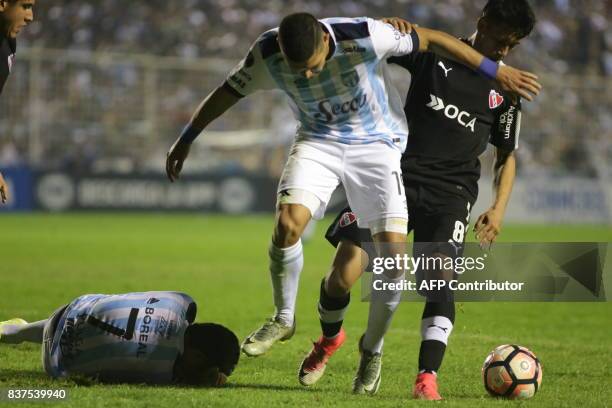 David Barbona of Atletico Tucuman disputes the ball with Maximiliano Meza of Independiente in their Copa Sudamericana 2017 match in the Jose Fierro...