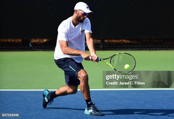 Viktor Troicki of Serbia returns a shot from Carlos Berlocq of Argentina during the fourth day of the Winston-Salem Open at Wake Forest University on...