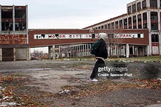 A person walks past the remains of the Packard Motor Car Company, which ceased production in the late 1950`s, November 19, 2008 in Detroit, Michigan....