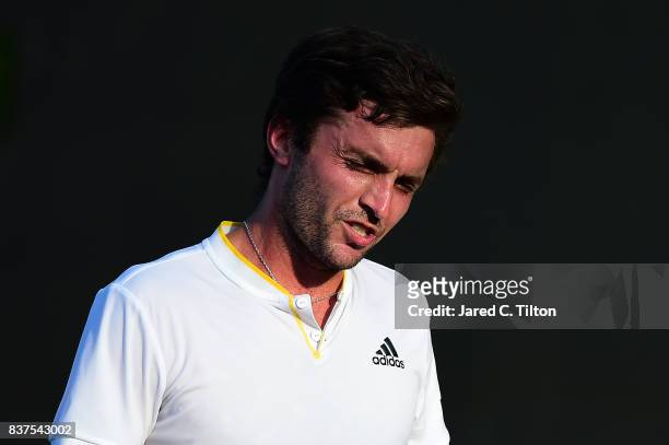 Gilles Simon of France reacts after a point against Damir Dzumhur of Bosnia during the fourth day of the Winston-Salem Open at Wake Forest University...