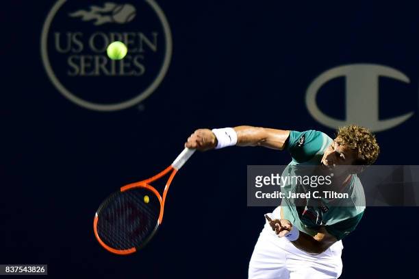 Pablo Carreno Busta of Spain serves to Julien Benneteau of France during the fourth day of the Winston-Salem Open at Wake Forest University on August...