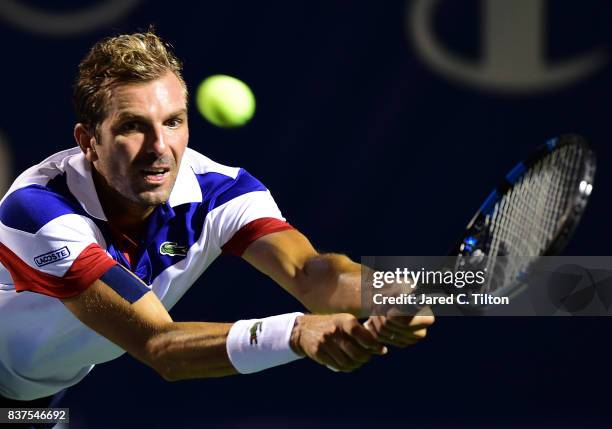 Julien Benneteau of France returns a shot from Pablo Carreno Busta of Spain during the fourth day of the Winston-Salem Open at Wake Forest University...