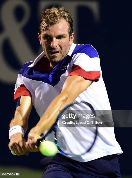 Julien Benneteau of France returns a shot from Pablo Carreno Busta of Spain during the fourth day of the Winston-Salem Open at Wake Forest University...