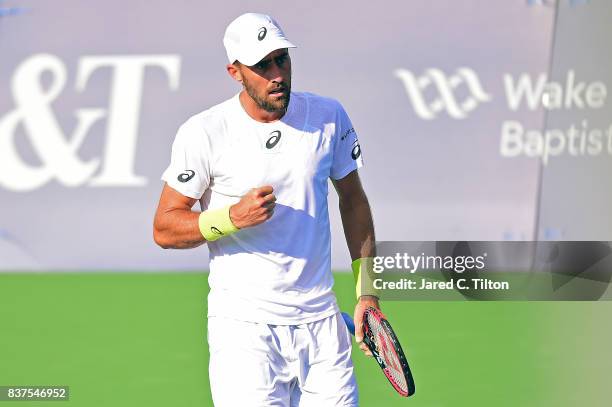 Steve Johnson reacts after a point against Yen-Hsun Lu of Chinese Taipei during the fourth day of the Winston-Salem Open at Wake Forest University on...