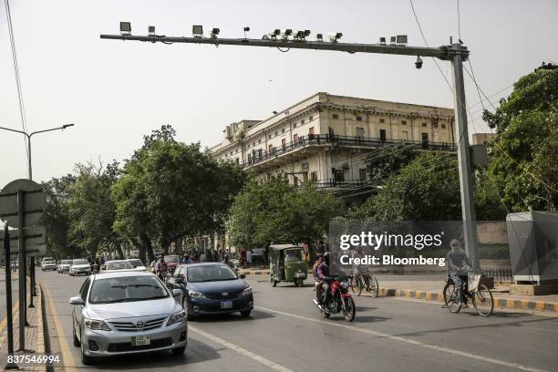 Security cameras operate above a road in Lahore, Pakistan, on Tuesday, June 13, 2017. While militants the U.S. Identifies as terrorists find refuge...
