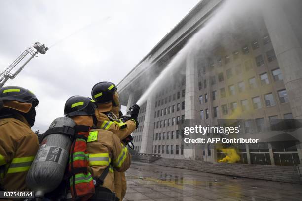 Firefighters participate in an anti-terror drill at the National Assembly in Seoul on August 23 on the sidelines of a South Korea-US joint military...