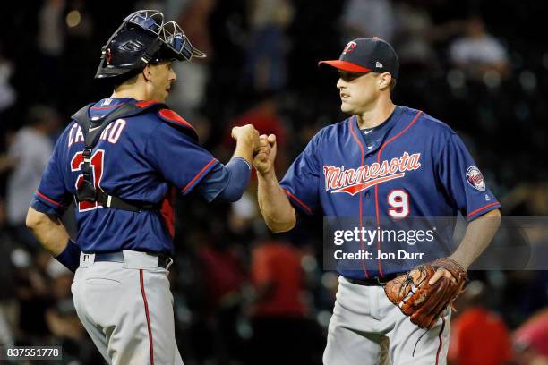 Matt Belisle of the Minnesota Twins and Jason Castro fist bump after their win over the Chicago White Sox at Guaranteed Rate Field on August 22, 2017...