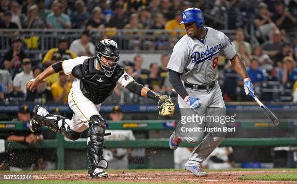 Elias Diaz of the Pittsburgh Pirates tags out Yasiel Puig of the Los Angeles Dodgers after a dropped third strike call in the fifth inning during the...