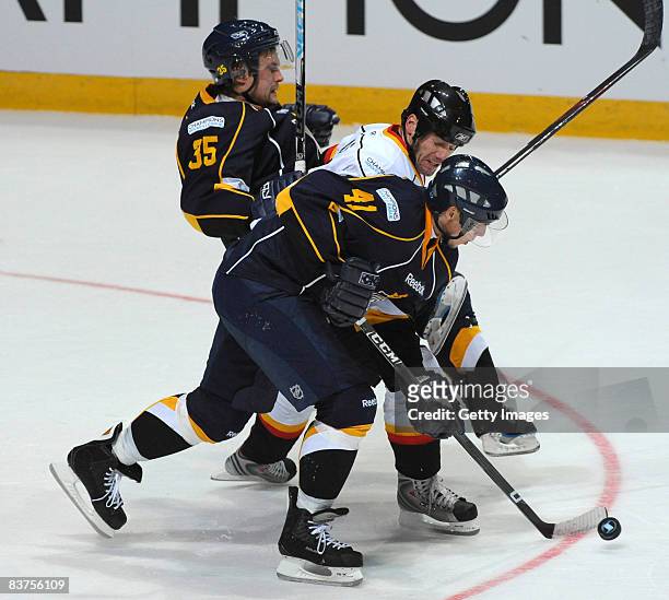 Stefan Ohman of Espoo Blues and Petri Kokko of Espoo Blues fight for the puck during the IIHF Champions Hockey League match between Espoo Blues and...