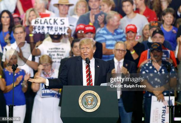 President Donald Trump gestures to the crowd as he speaks to supporters at the Phoenix Convention Center during a rally on August 22, 2017 in...