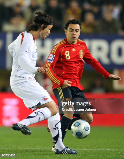 Waldo Ponce of Chile duels for the ball with Xavier Hernandez of Spain during the international friendly match between Spain and Chile at the El...