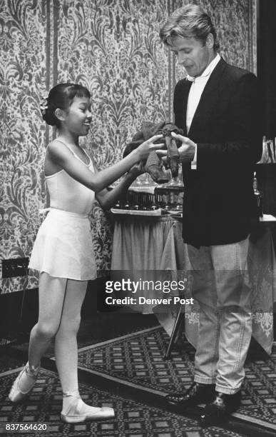 Mikhail Baryshnikov receives a gift from Annelsie Hansen, age 11 at the Fairmont Hotel Friday night. Credit: The Denver Post