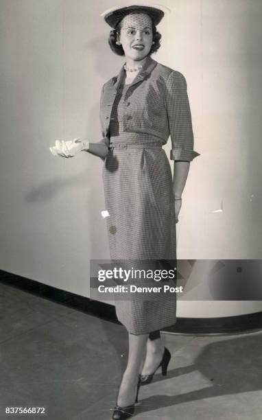 Campbell, Donald C. Mrs Fashion show model Hattie Carnegie's pin - check wool costume features self-material detail and tabs on the brief jacket and...