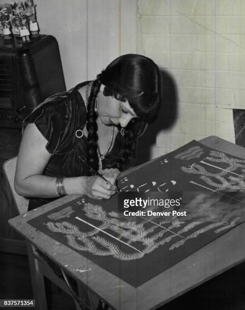 American artist Pop Chalee works on a painting in her studio, 29th December 1957.