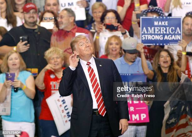 President Donald Trump gestures during a rally at the Phoenix Convention Center on August 22, 2017 in Phoenix, Arizona. An earlier statement by the...