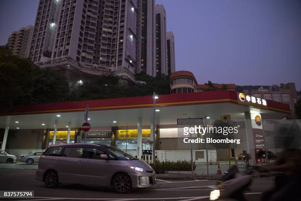 Vehicles pass a PetroChina Co. Gas station at dusk in Hong Kong, China, on Monday, Aug. 21, 2017. PetroChina is scheduled to report the...