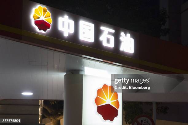 The PetroChina Co. Logo stands illuminated atop one of the company's gas stations at night in Hong Kong, China, on Monday, Aug. 21, 2017. PetroChina...