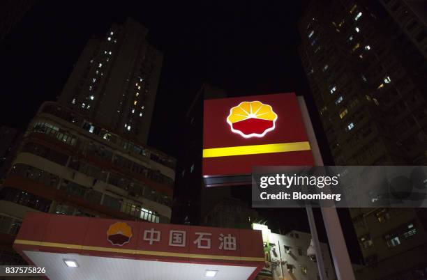 The PetroChina Co. Logo stands illuminated atop one of the company's gas stations at night in Hong Kong, China, on Monday, Aug. 21, 2017. PetroChina...