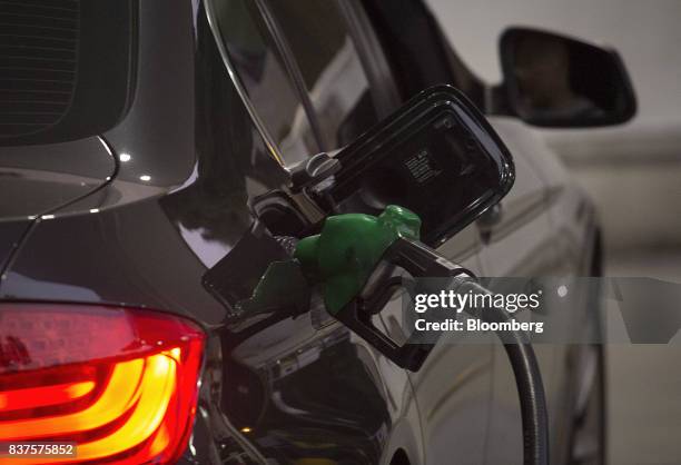 Fuel nozzle sits in a vehicle at a PetroChina Co. Gas station at night in Hong Kong, China, on Monday, Aug. 21, 2017. PetroChina is scheduled to...