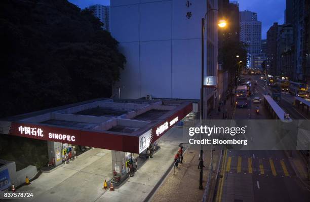 China Petroleum & Chemical Corp. Gas station stands at dusk in Hong Kong, China, on Tuesday, Aug. 22, 2017. Sinopec is scheduled to report...