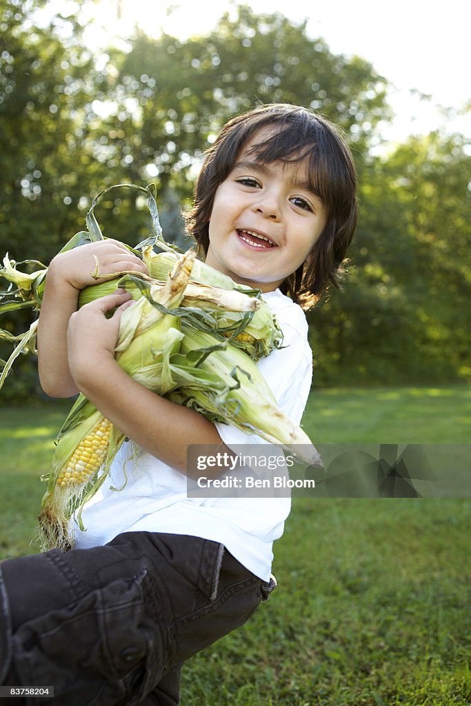 Boy holding Corn 