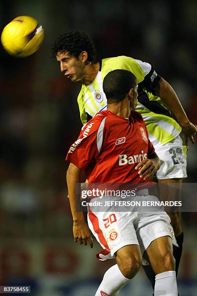 Chivas' Antonio Salazar Castillo and Internacional's Taison vie for the ball during their Copa Sudamericana semifinal match in Porto Alegre, Brazil,...