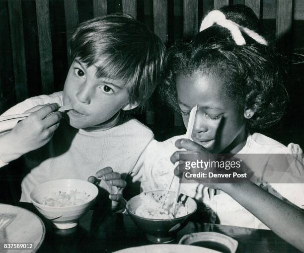 Teddy Borst And La Ronda Russell Enjoy Their Meal They were taught how to use chopsticks by the restaurant hostesses. Credit: Denver Post