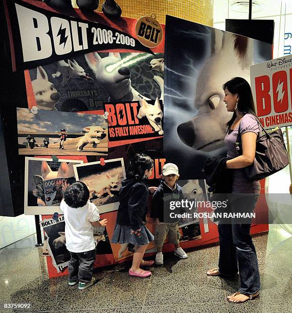 Lifestyle-entertainment-film-cinema-3D-Hollywood by Martin Abbugao Children stand in front of the billboard of a 3D animation movie outside a cinema...