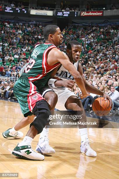 Miles of the Utah Jazz tries to make a move on Charlie Bell the Milwaukee Bucks at EnergySolutions Arena on November 19, 2008 in Salt Lake City,...