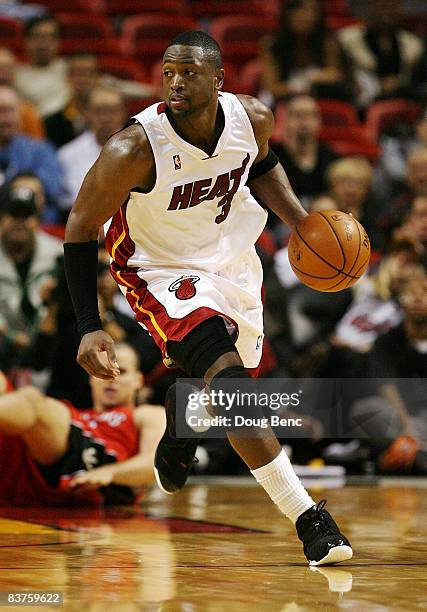 Dwyane Wade of the Miami Heat brings the ball up court against the Toronto Raptors at American Airlines Arena on November 19, 2008 in Miami, Florida....