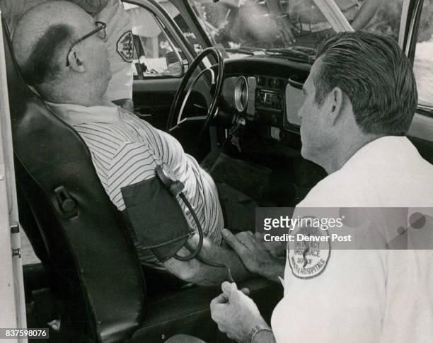 Accident Victim Checked Reid Waltman of 10210 W. Exposition Ave., Lake­wood, is administered to by Kenneth Edwards, a Denver General Hospital...