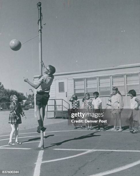 Patty Gasaway of Barnum School, Mike Heit of Presentation play tether ball. Credit: Denver Post