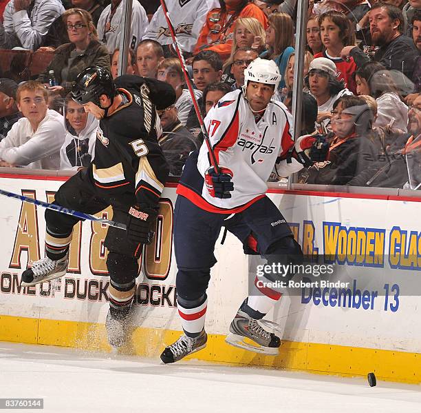 Donald Brashear of the Washington Capitals battles for the puck along the boards against Steve Montador of the Anaheim Ducks in NHL action November...