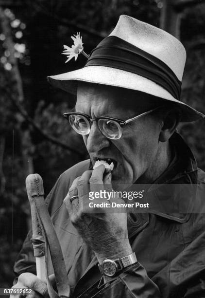 Wilbert J. Moehrke, partially sighted, takes a bite of an edible mushroom identified on the trip. Moehrke, a member of the Colorado Mountain Club,...