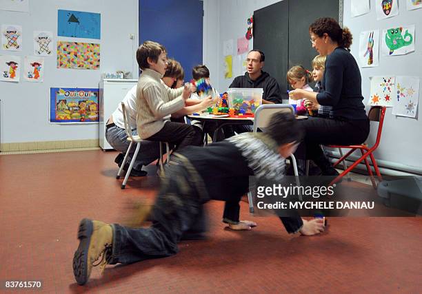 Educators attend chidren in a temporary daycare center set up on Novembre 20 in Herouville-Saint-Clair, northwestern France, on a national teachers'...