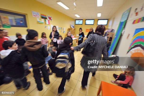Woman takes a child to a temporary daycare center set up on Novembre 20 in Herouville-Saint-Clair, northwestern France, on a national teachers'...