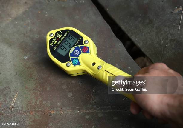 Geiger counter maxes out at 999,000 counts per minute inside a metal claw contaminated with radioactivity in the ghost town of Pripyat not far from...