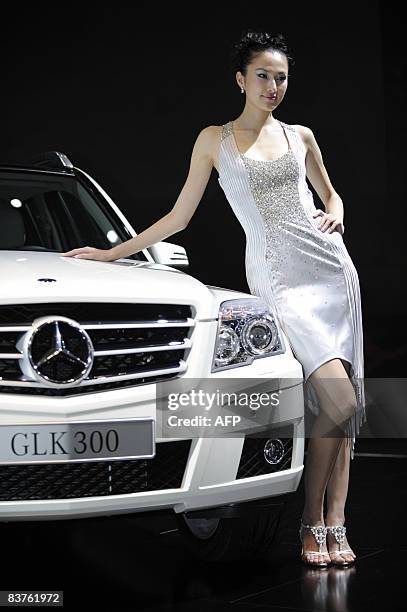 Chinese hostess poses with a Mercedes Benz GLK300 model at the Guangzhou International Auto Show in Guangzhou, in southern China's Guangdong province...