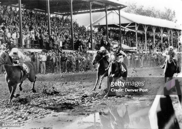 Off To A Flying Start- High Flying , owned by Andy Thomas and Piloted by Duane Robertson, gets off to a flying Start in the mud before a packed...