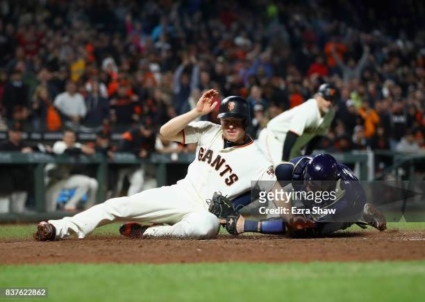 Manny Pina of the Milwaukee Brewers tags out Nick Hundley of the San Francisco Giants at home plate in the eighth inning at AT&T Park on August 22,...