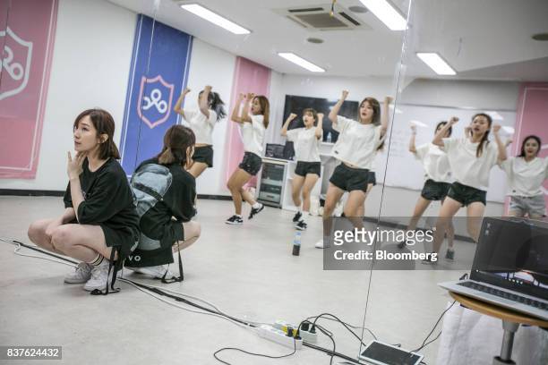 Dance instructor, left, watches as contestants practice dance moves during the production of the "Idol School" reality television show by CJ E&M...
