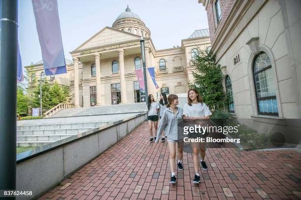 Contestants Yoo Ji-na, from left, Jang Gyu-ri, Cho Young-ju, and Tasha walk through Yangpyeong English School during the production of the "Idol...